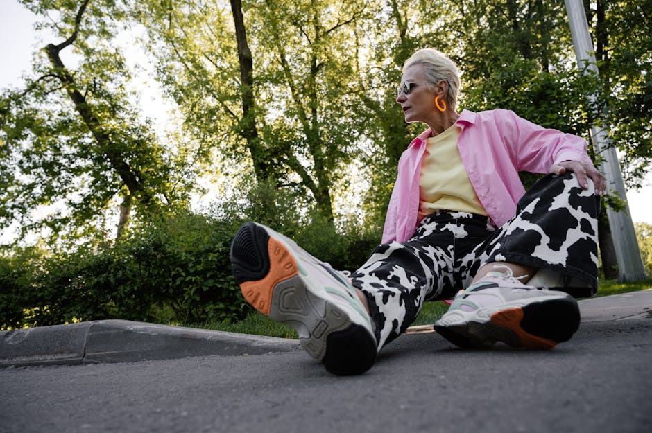 Elegant elderly woman in colorful attire relaxing outdoors, showcasing vibrant fashion style with animal print designs.